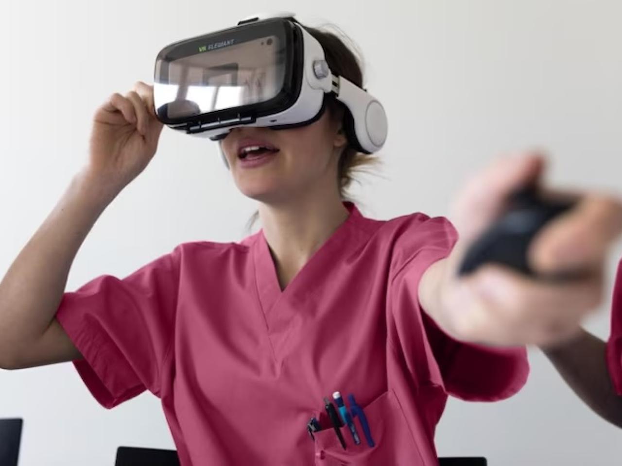 Female technician shown wearing virtual reality glasses and wearing scrubs.