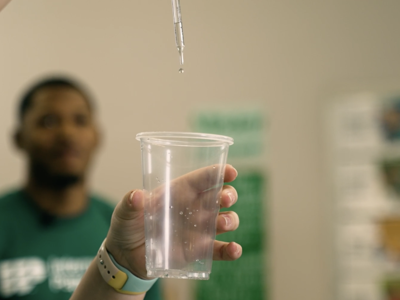 Person holding a cup of water