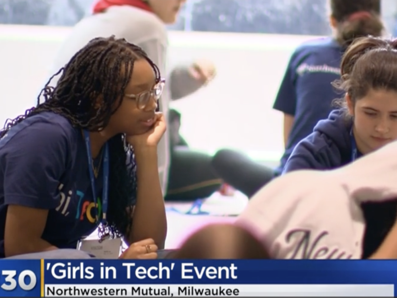Young women in lanyards working together at a group event