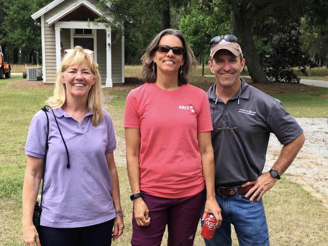 three people standing together outside